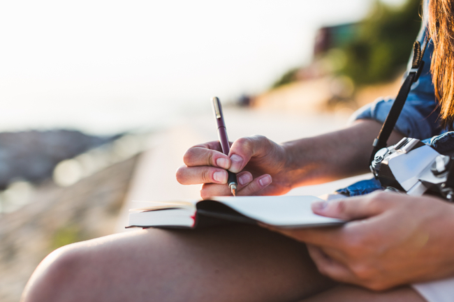 Woman writing on her diary